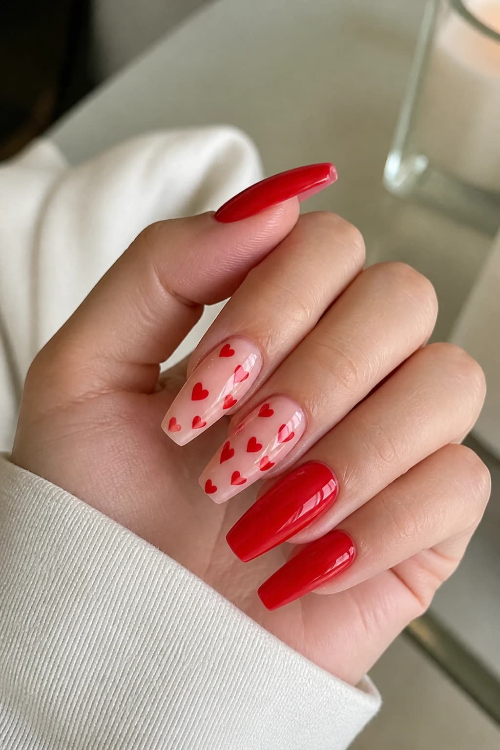 Coffin nails in red with a heart design and a glossy finish