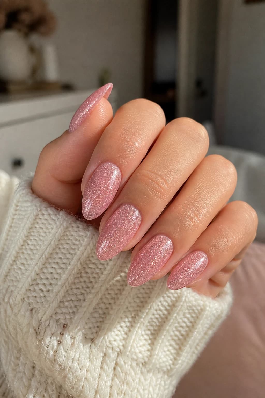 Medium almond nails in pink with a glitter finish