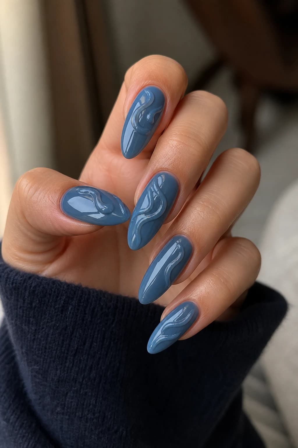 Long almond nails in blue with a 3D design and a glossy finish, fall nail design