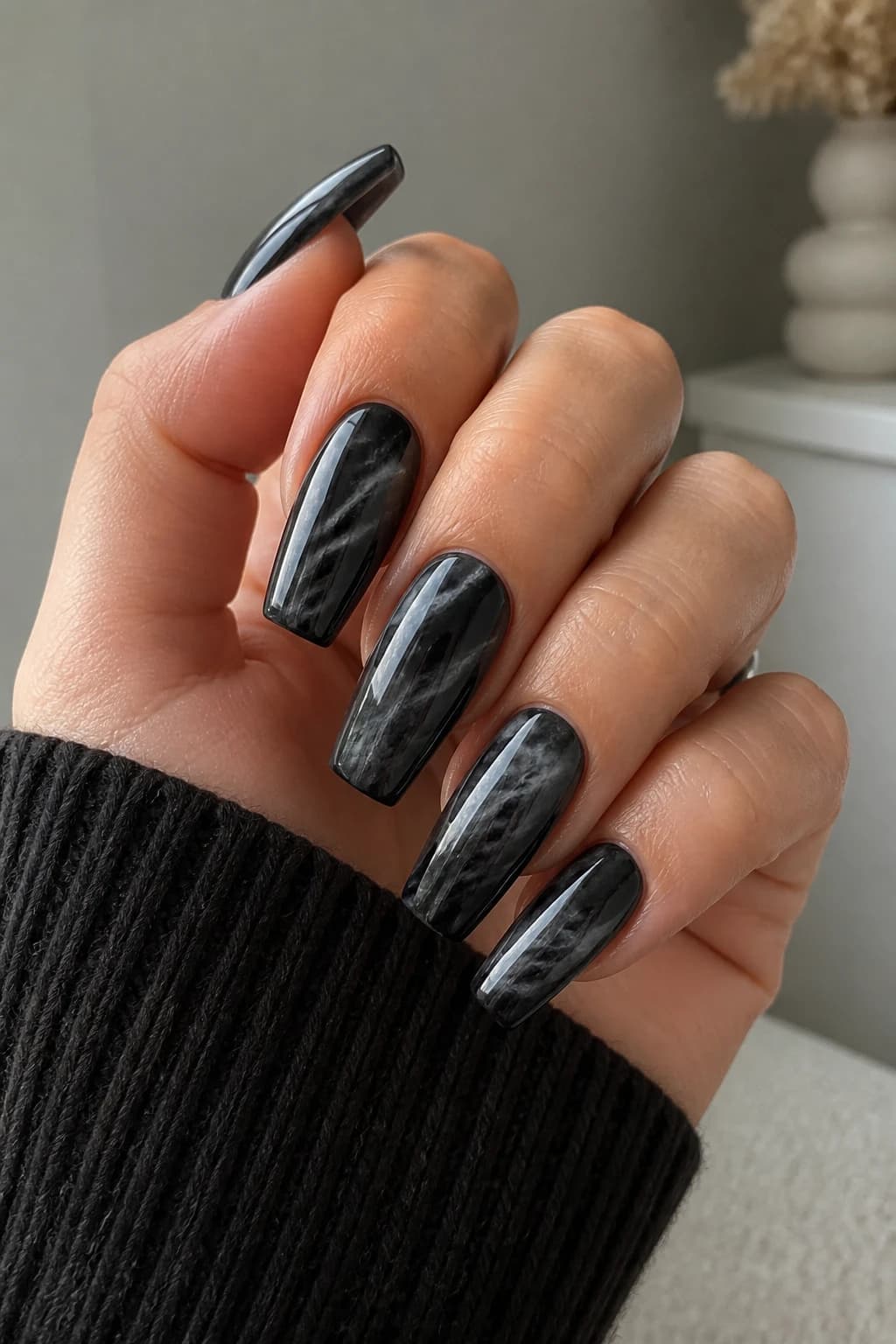 Long coffin nails in black with a marble design and a chrome finish, fall nail design