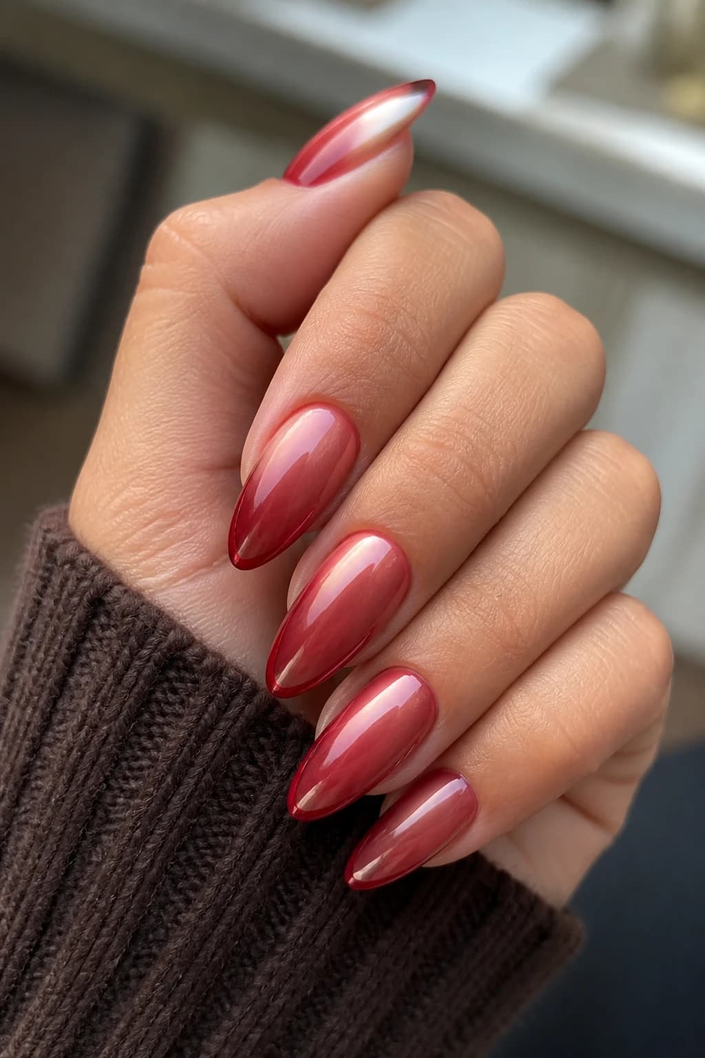 Long almond nails in red with a micro French design and a chrome finish, fall nail design