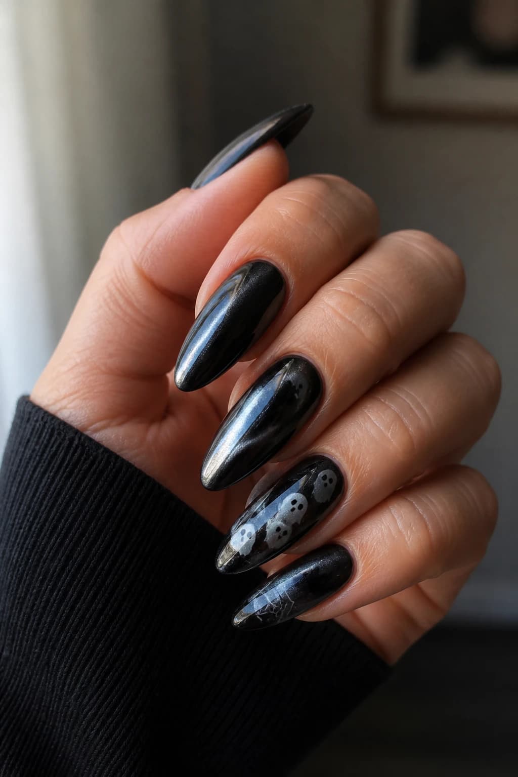 Long almond nails in black with a chrome finish, Halloween nail design