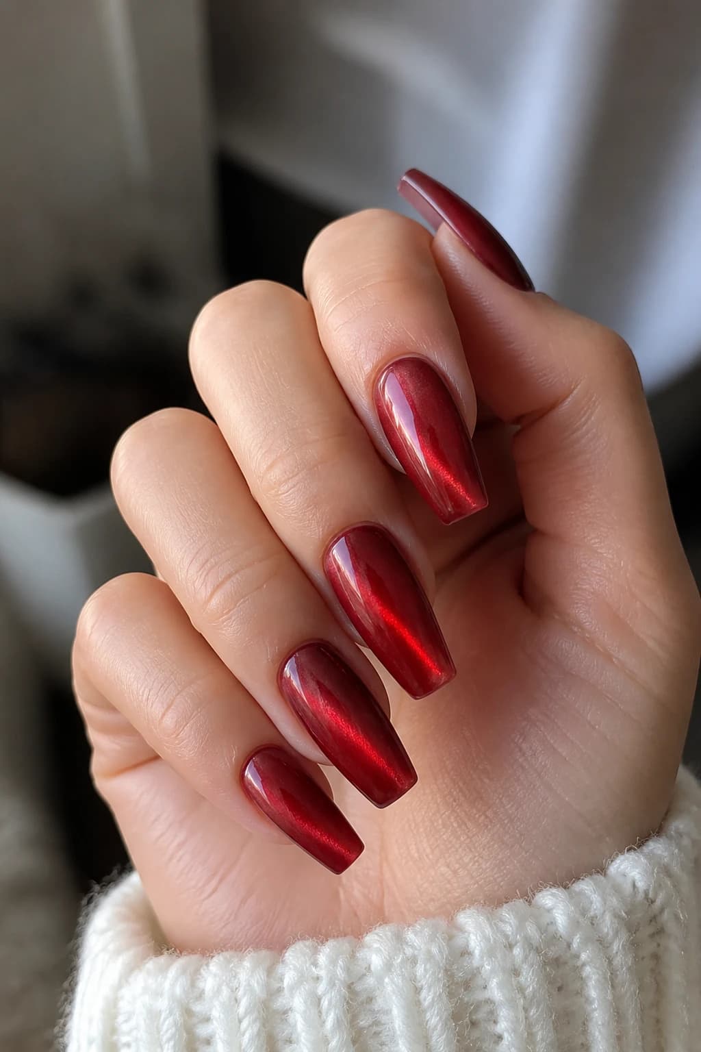 Long coffin nails in red with a jelly design and a cat eye finish