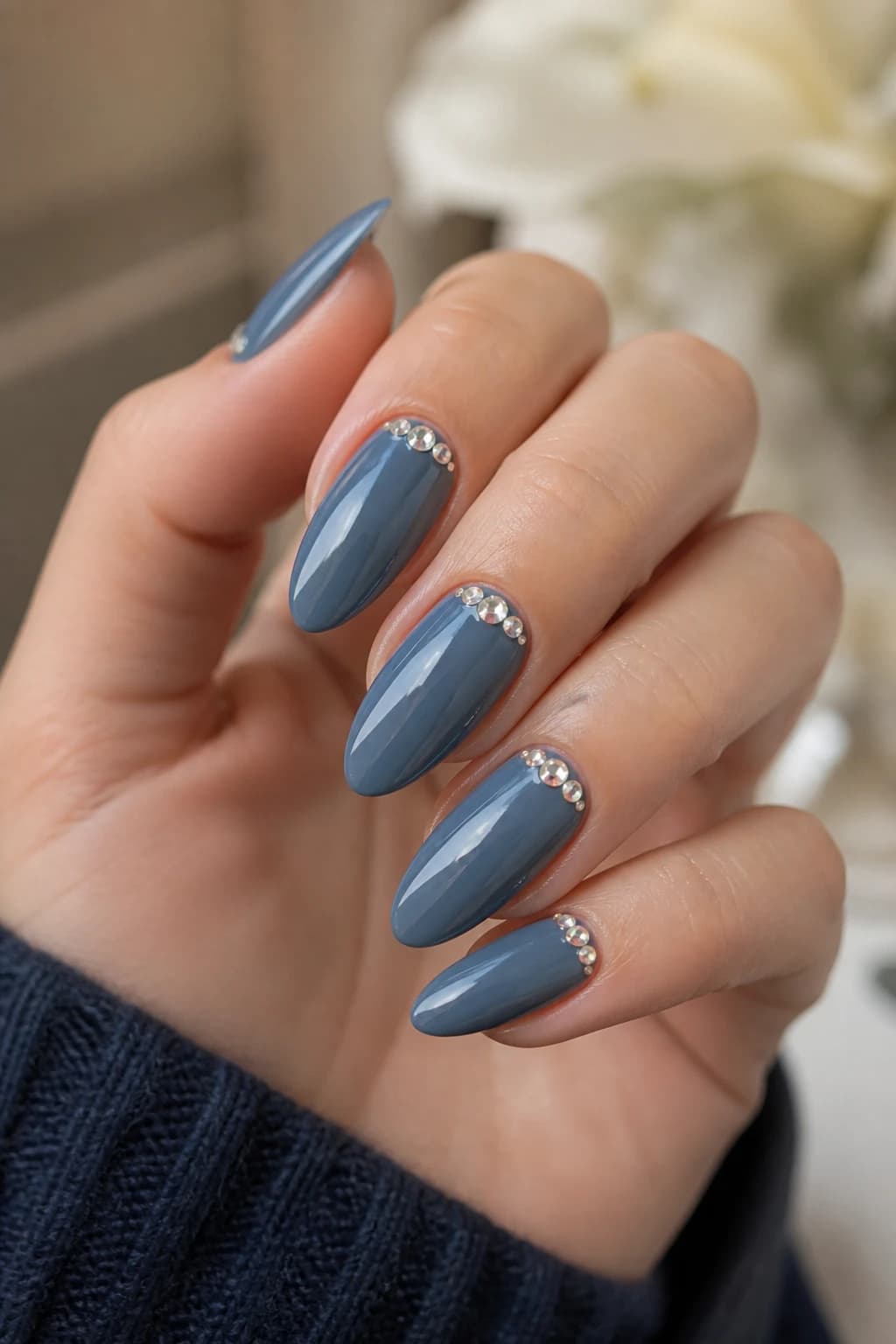 Long almond nails in blue with a rhinestone design and a glossy finish, fall nail design