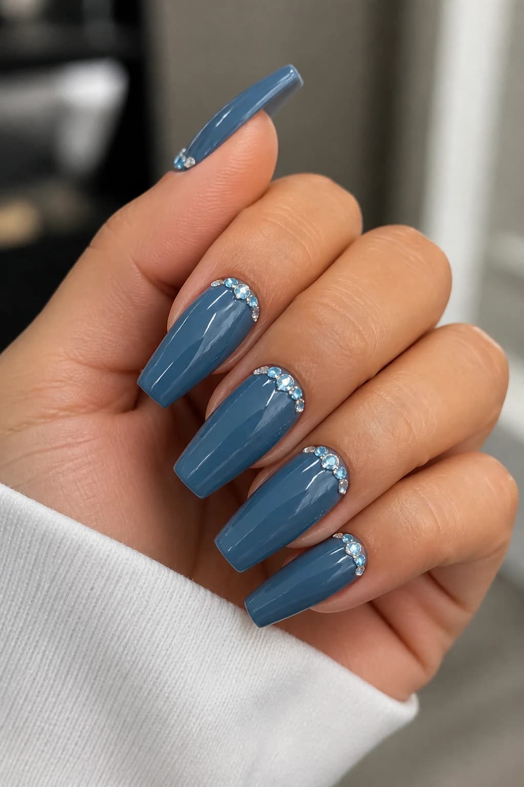 Long coffin nails in blue with a rhinestone design and a glossy finish, fall nail design