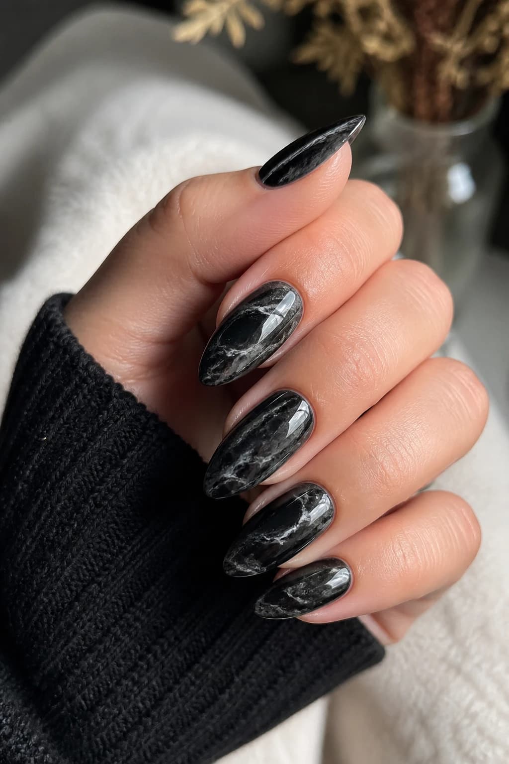 Long almond nails in black with a marble design and a chrome finish, fall nail design