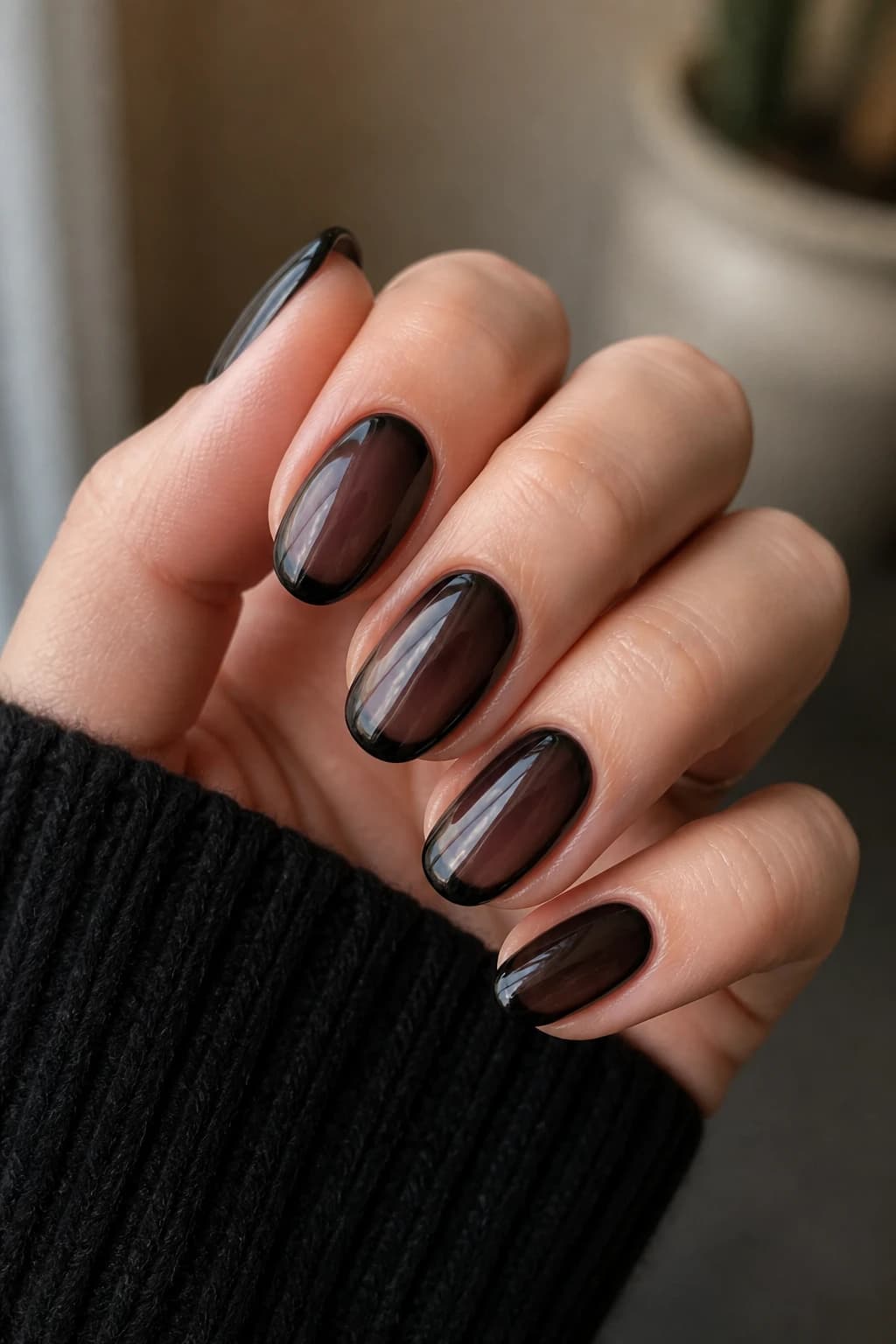 Medium oval nails in black with a jelly design and a chrome finish, fall nail design