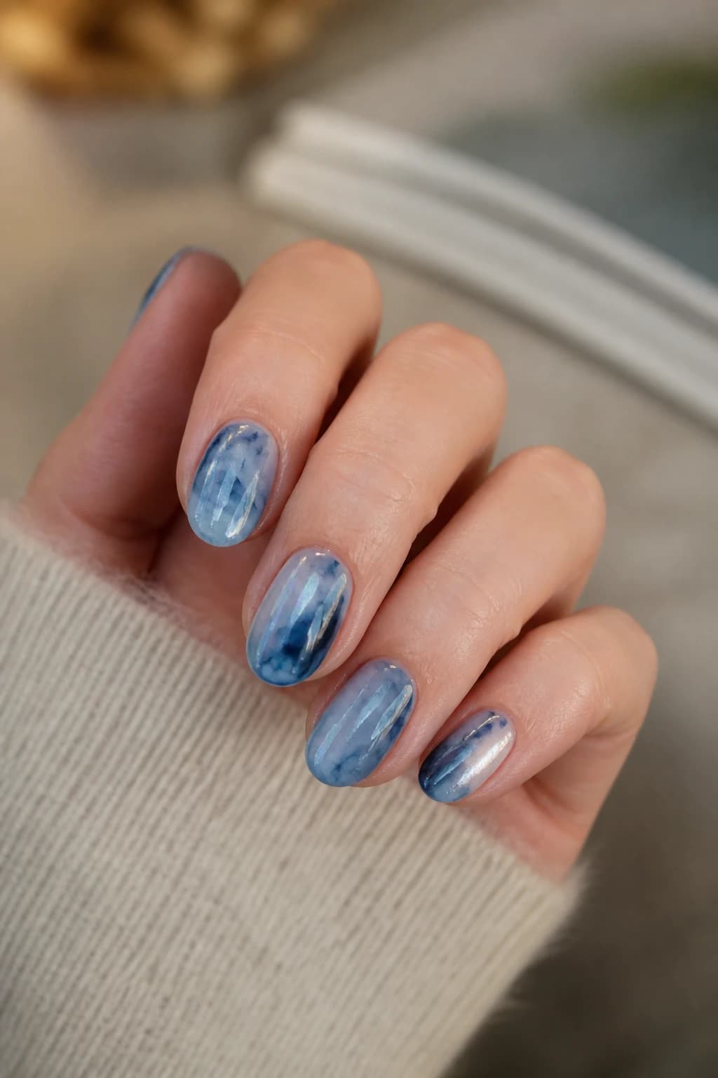 Medium oval nails in blue with a blooming gel design and a chrome finish, fall nail design