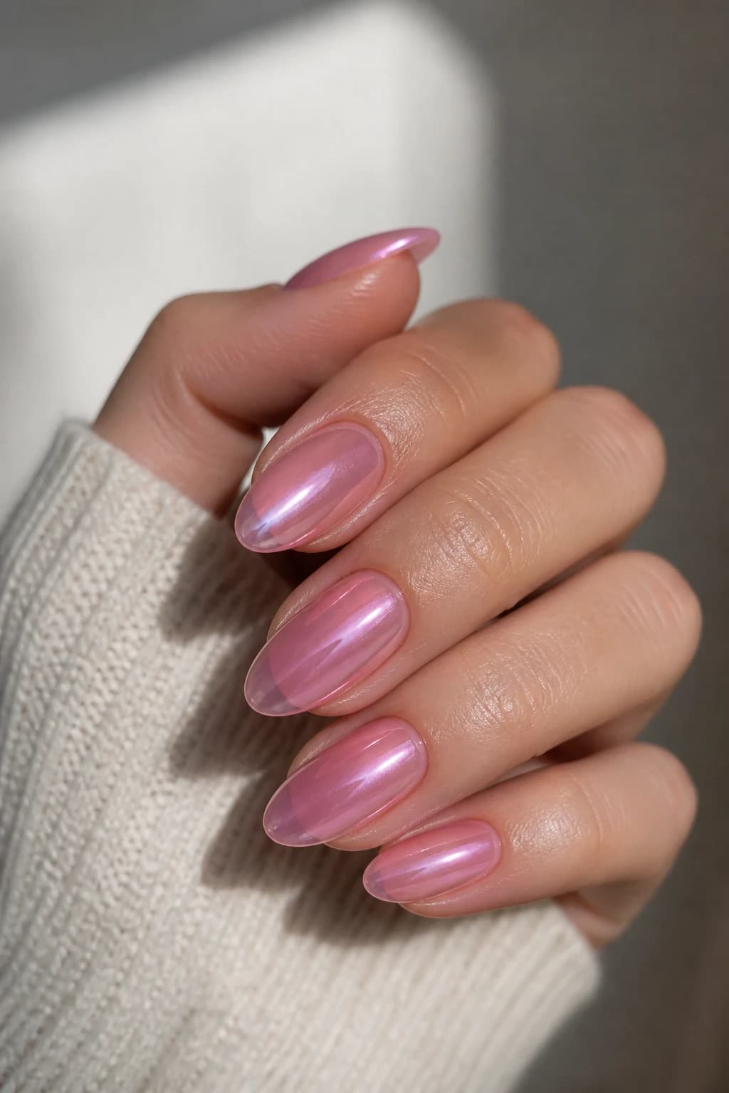 Long almond nails in pink with a jelly design and a chrome finish