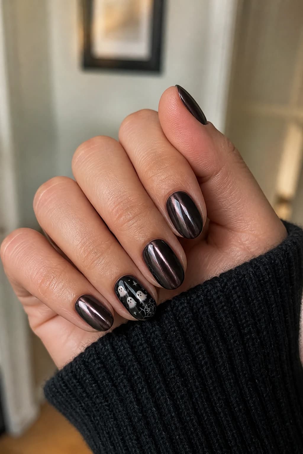 Short almond nails in black with a chrome finish, Halloween nail design