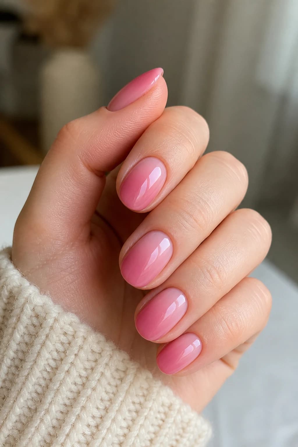 Medium round nails in pink with an ombré design and a glossy finish, fall nail design