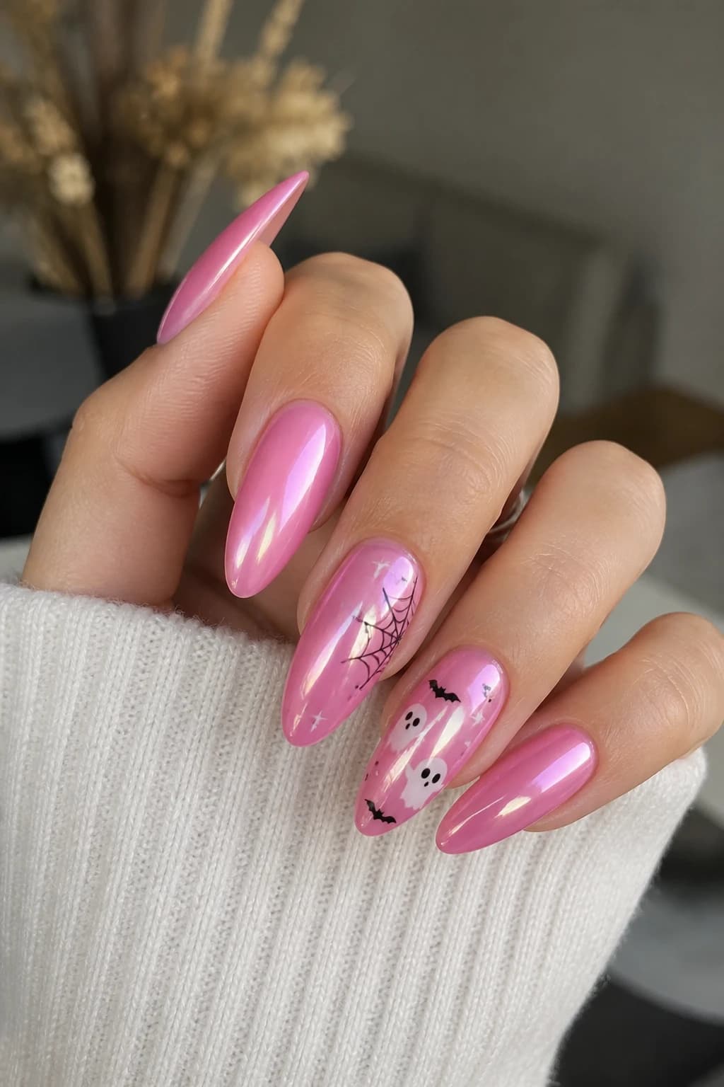 Long almond nails in pink with a chrome finish, Halloween nail design
