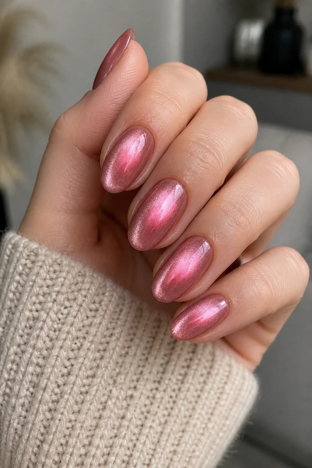 Medium oval nails in pink with an aura design and a cat eye finish, fall nail design
