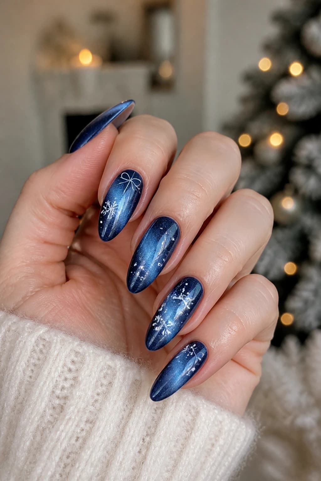 Long almond nails in blue with a cat eye finish, Christmas nail design