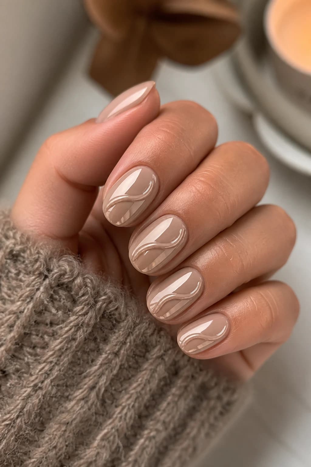 Medium round nails in nude with a 3D design and a chrome finish, fall nail design