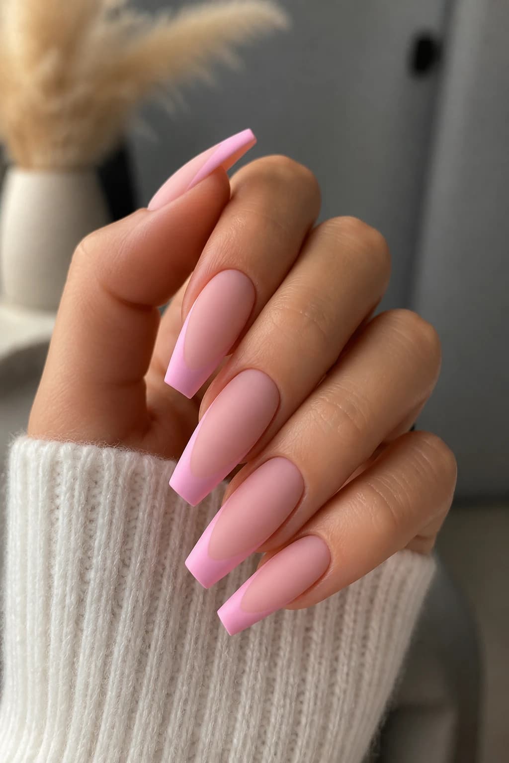 Long coffin nails in pink with a French tip design and a matte finish