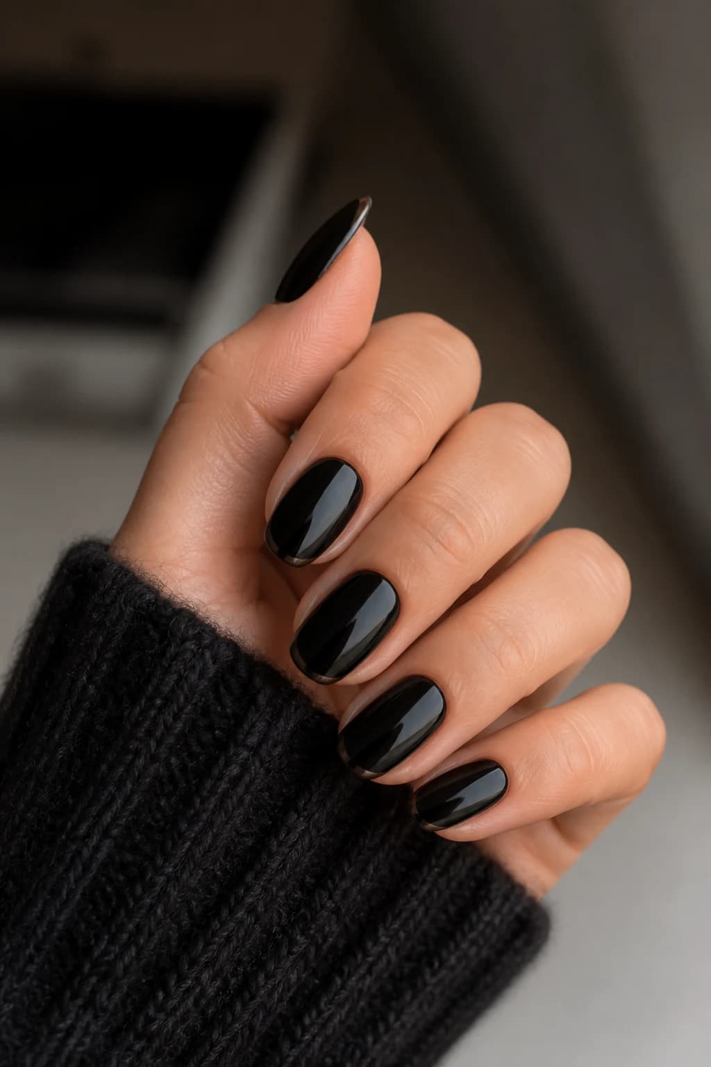 Medium oval nails in black with a micro French design and a glossy finish, fall nail design