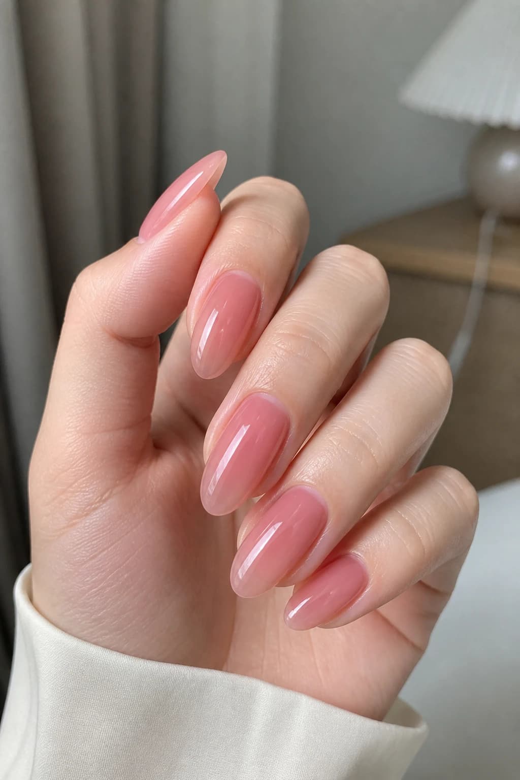 Long almond nails in pink with a jelly design and a glossy finish
