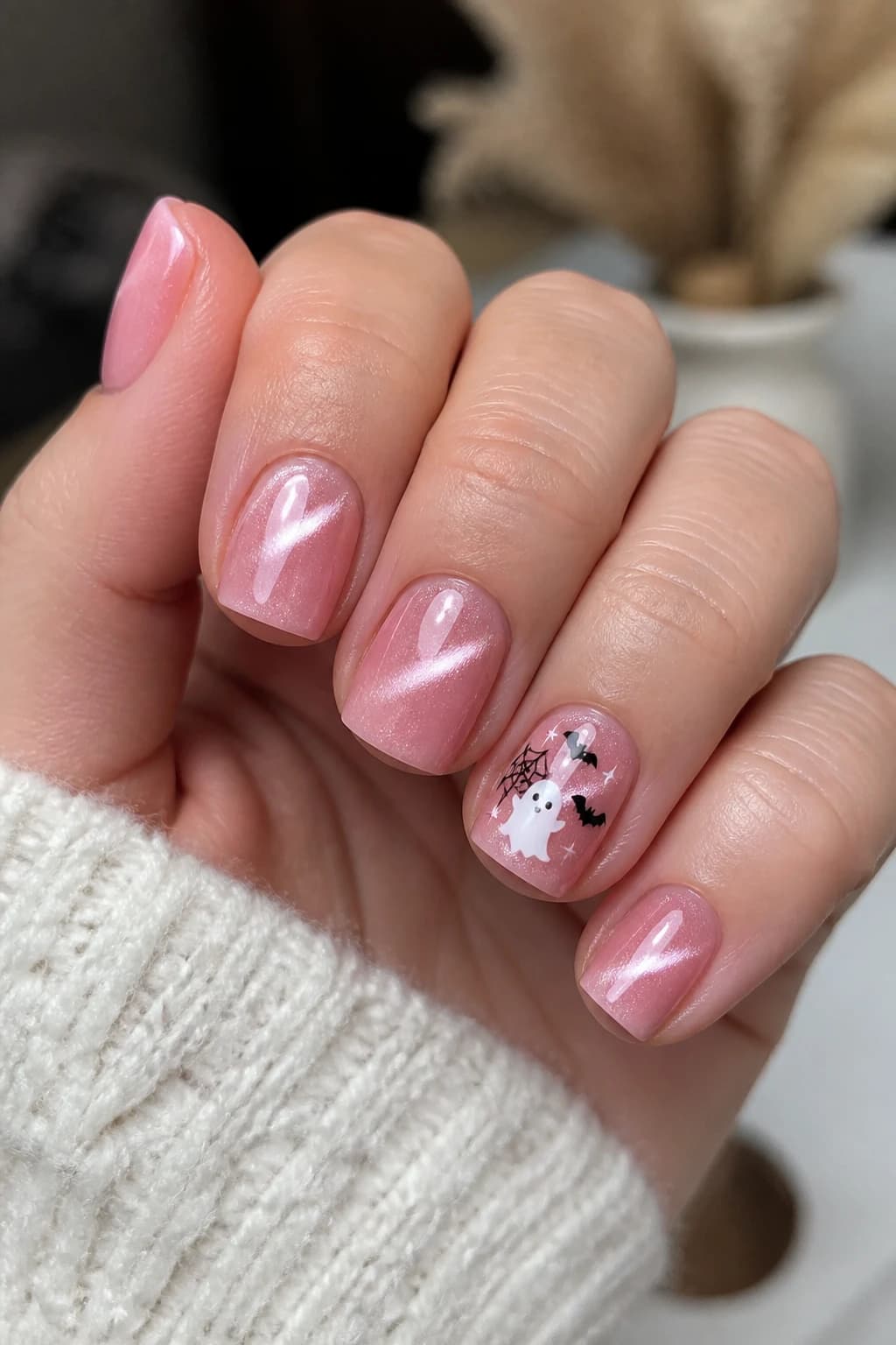 Short coffin nails in pink with a cat eye finish, Halloween nail design