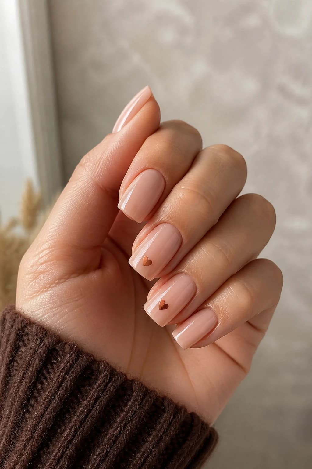 Medium square nails in nude with a heart design and a chrome finish, fall nail design