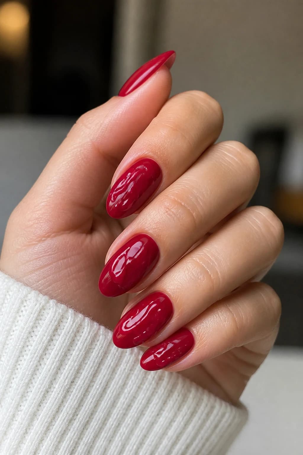 Long oval nails in red with a 3D design and a glossy finish