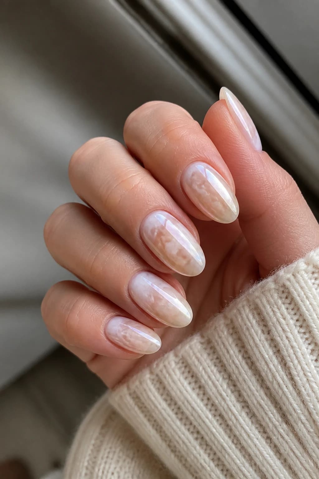 Long almond nails in white and cream with a blooming gel design and a chrome finish