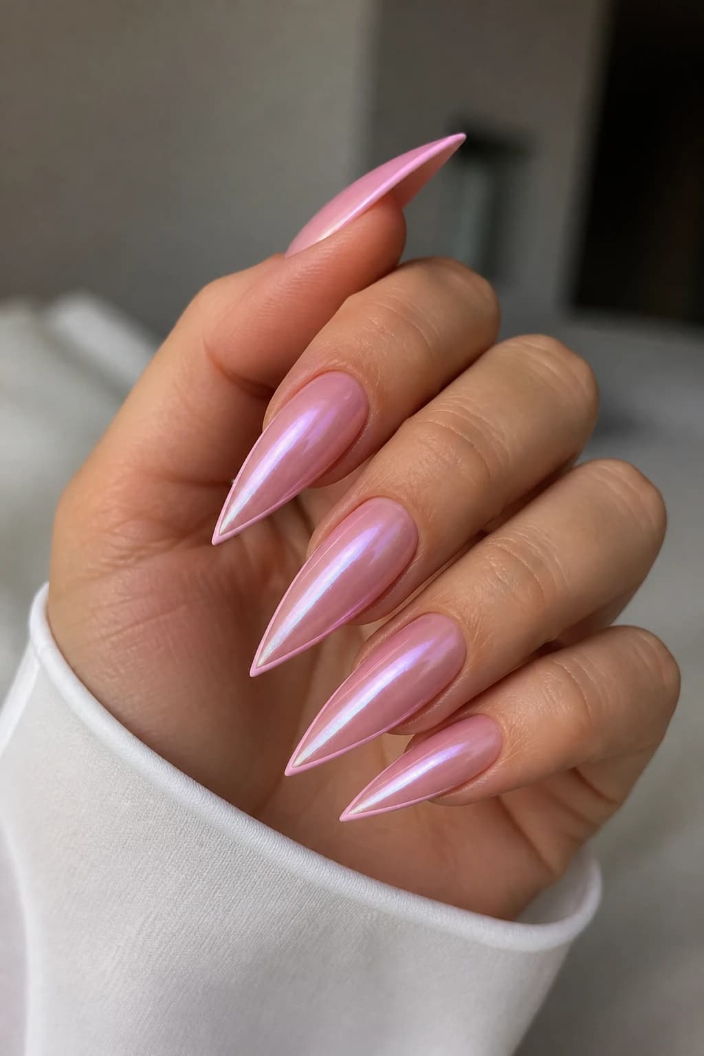 Long stiletto nails in pink with a micro French design and a chrome finish