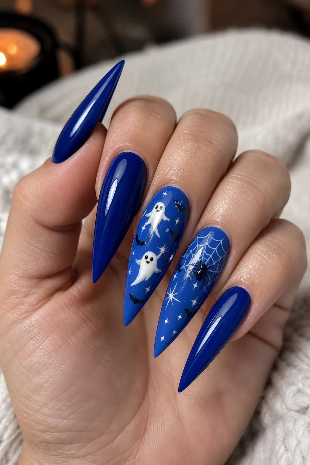 Long stiletto nails in blue with a glossy finish, Halloween nail design